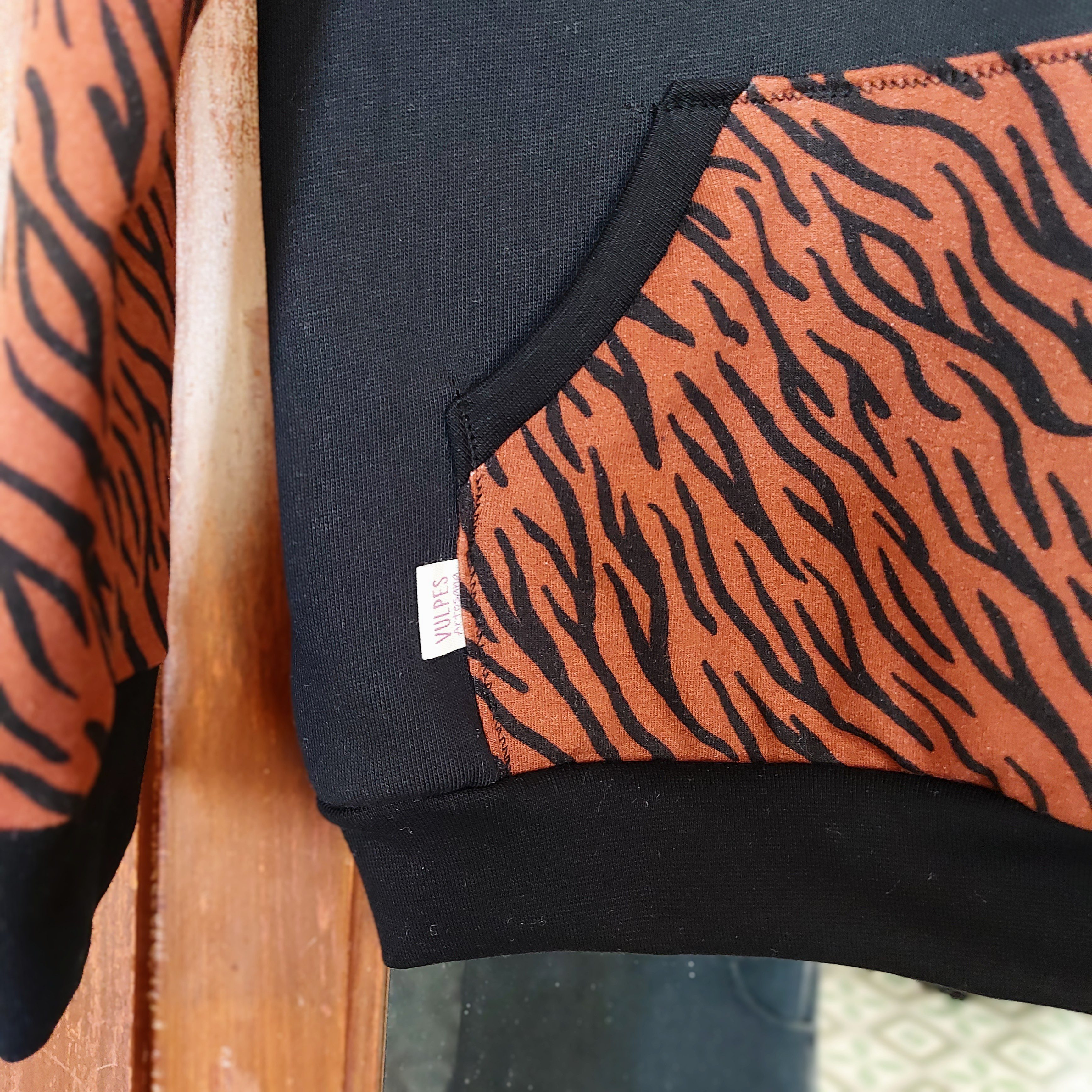 Sudadera ecológica Bea en algodón orgánico negro con mangas y bolsillo estampados, detalle